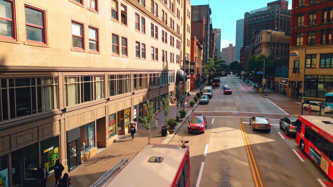Pittsburgh, USA, 2 August 2025: Wide cozy street of Pittsburg, Pennsylvania, USA. People walk by the sidewalk and transport moves by the road. Aerial view