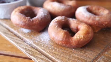 delicious homemade powdered donuts on a wooden board