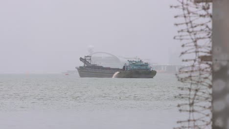 a ship is seen at the waterfront under heavy rain during a severe tropical typhoon storm signal t8 ma-on, which sustained winds of 63 miles and damaged the city of hong kong