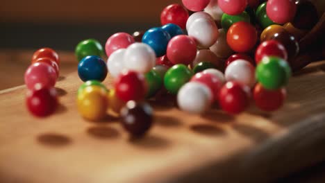 multicolored candy balls and a tree floor pass in front of the camera.