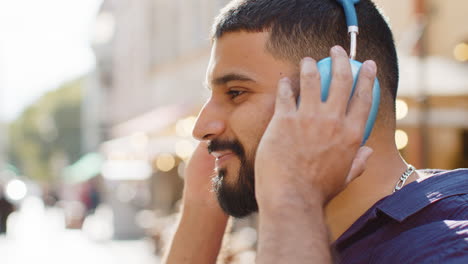 man listening to music in a city cafe