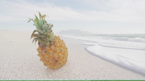 pineapple resting on sandy beach with ocean waves under cloudy sky