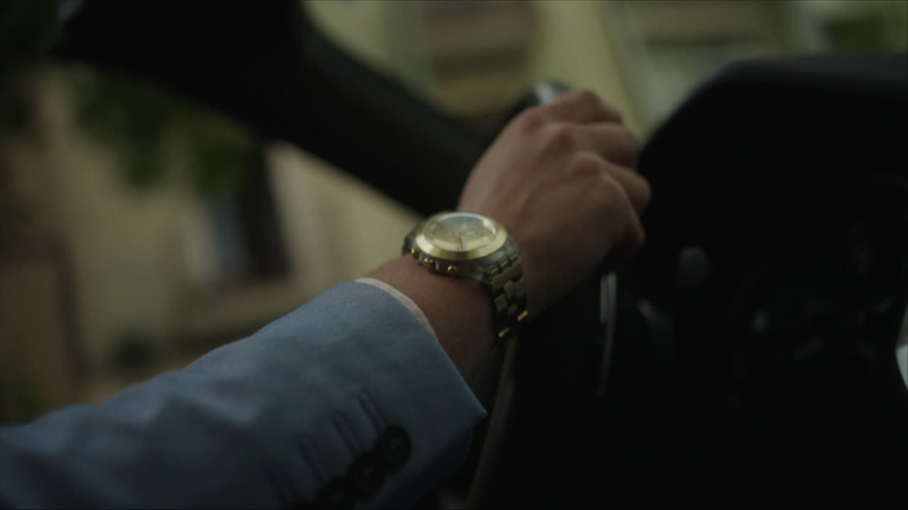 Man Driving a Car with a Wristwatch