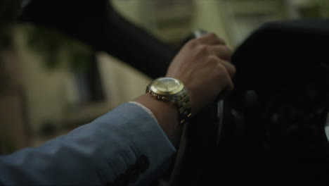 man driving a car with a wristwatch