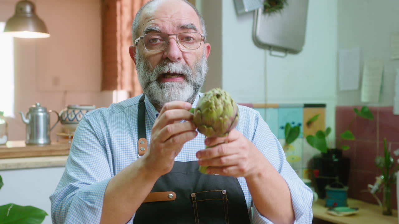 Man holding an artichoke