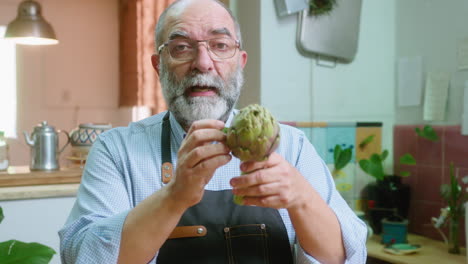 man holding an artichoke