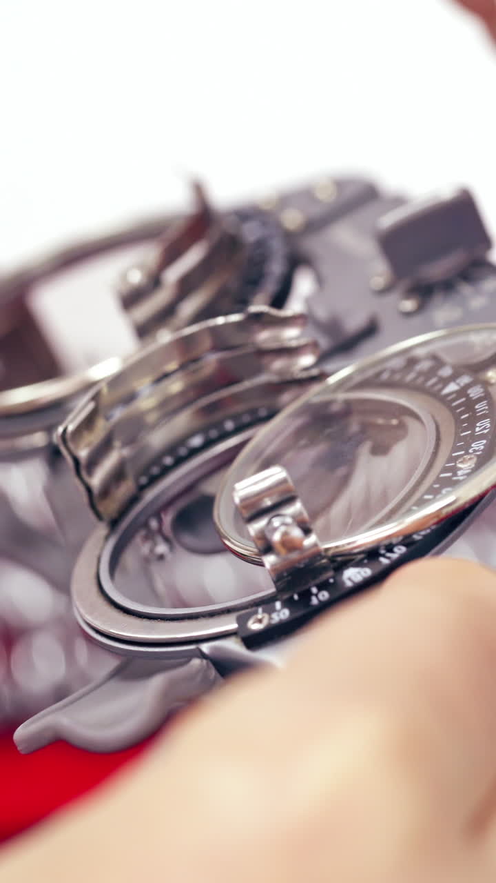 Concept of ophthalmology. Close-up view of glasses for testing eye on the background of lenses for checking visual acuity. Tools for checking and correction vision. Vertical video