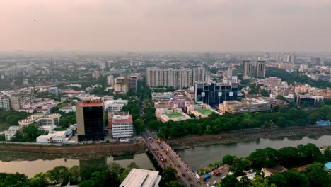 moving aerial view of business offices and residential buildings during evening. blurry cityscape.