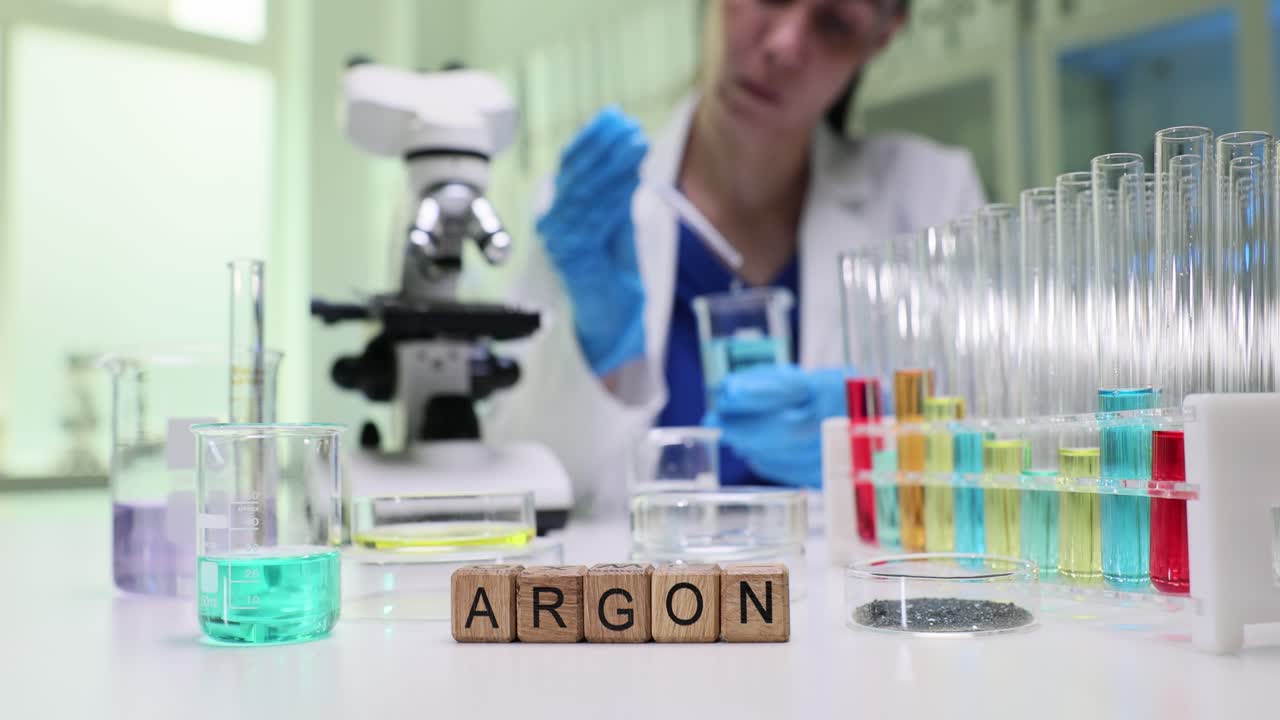 Scientist conducting an experiment in a laboratory with colorful liquids and lab equipment, with 'ARGON' spelled out on wooden blocks