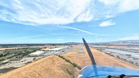 cessna 172 on final approach and landing in vacaville, california. smooth descent over fields and runway touchdown captured in clear daylight from cockpit or exterior perspective