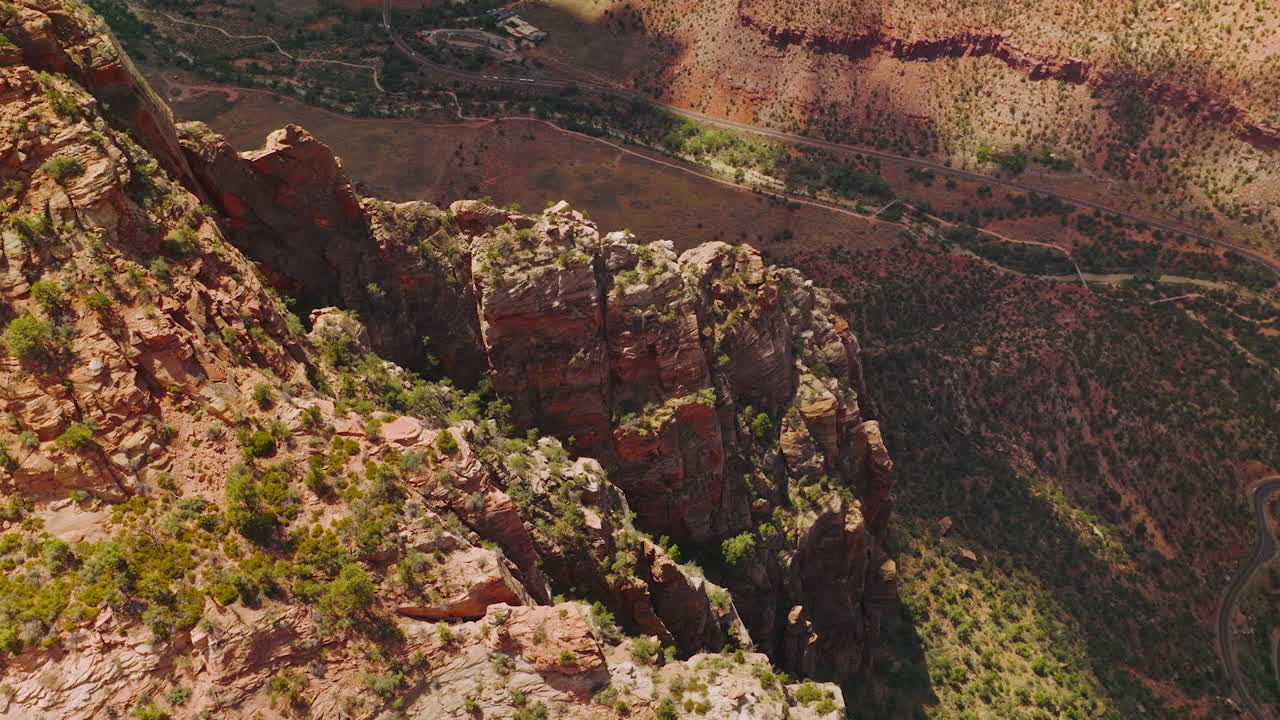 Looking at the tops of amazing canyons with little greenery. High sharp rocks towering over the desert in Utah, USA.