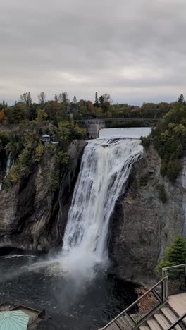 montmorency waterfall from distance, in quebec city canada with suspension bridge