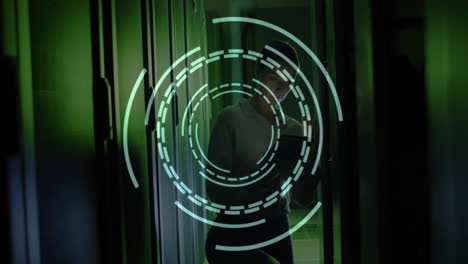 Digital target animation over person using tablet in dark server room
