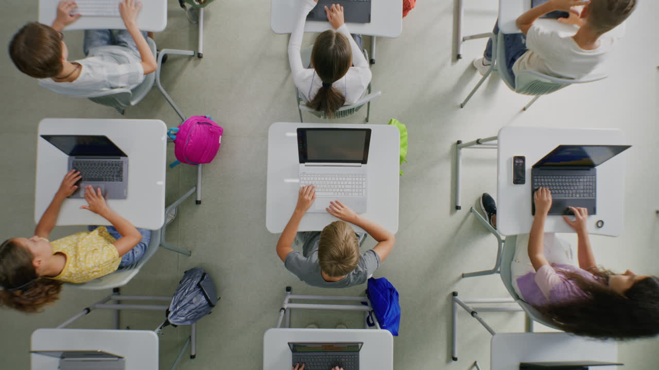 Primary School Students Working on Creative Projects on Computers Studying Programming