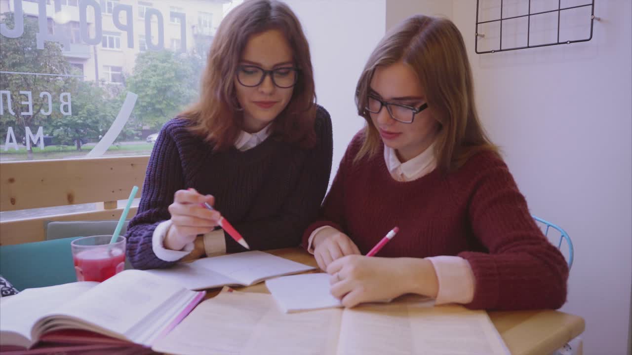 Two Girls Studying in a Cafe