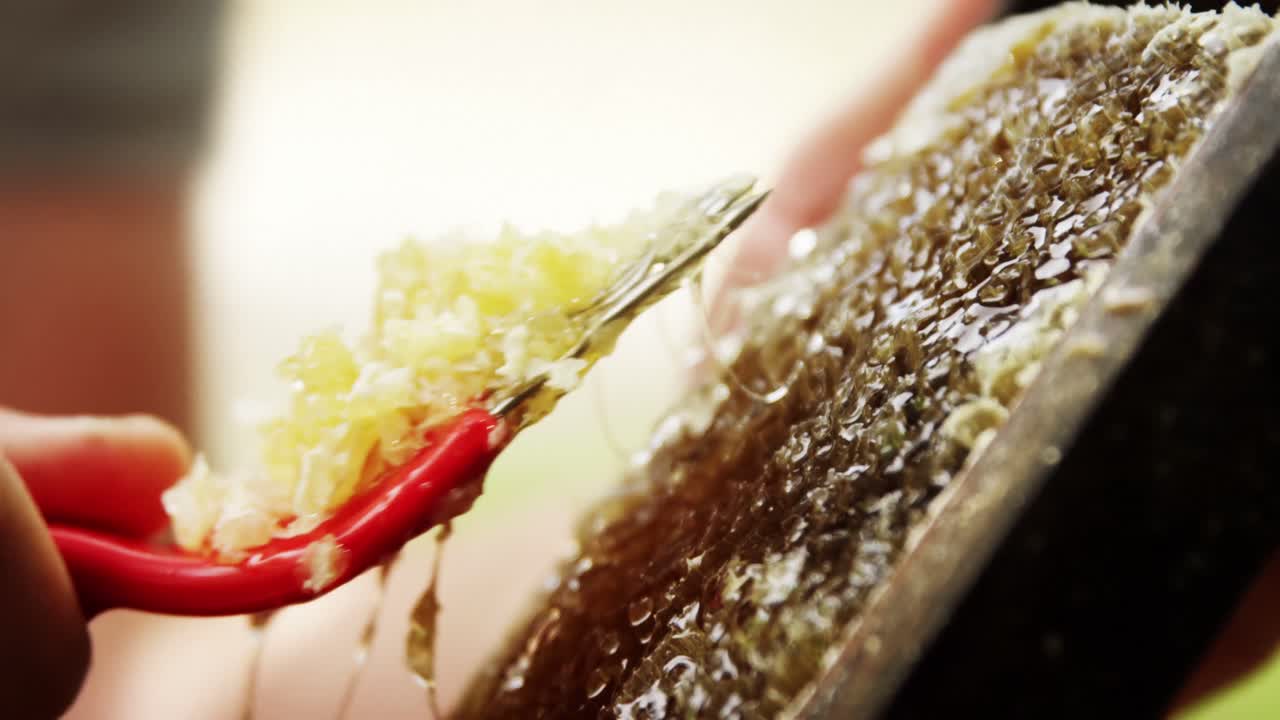 Beekeeper removing beeswax from beehive