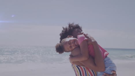 animation of light trails over african american woman and her daughter embracing at beach