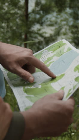 people navigating with a topographic map in nature