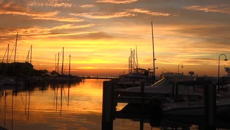 watching the sunset over a lake full of yachts and sailboats which is making silhouettes.