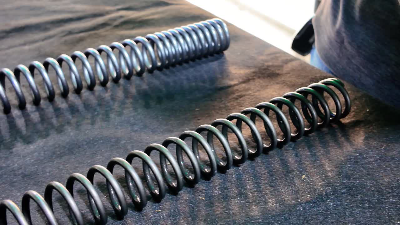 Comparison motorcycle suspension springs old vs new close-up view