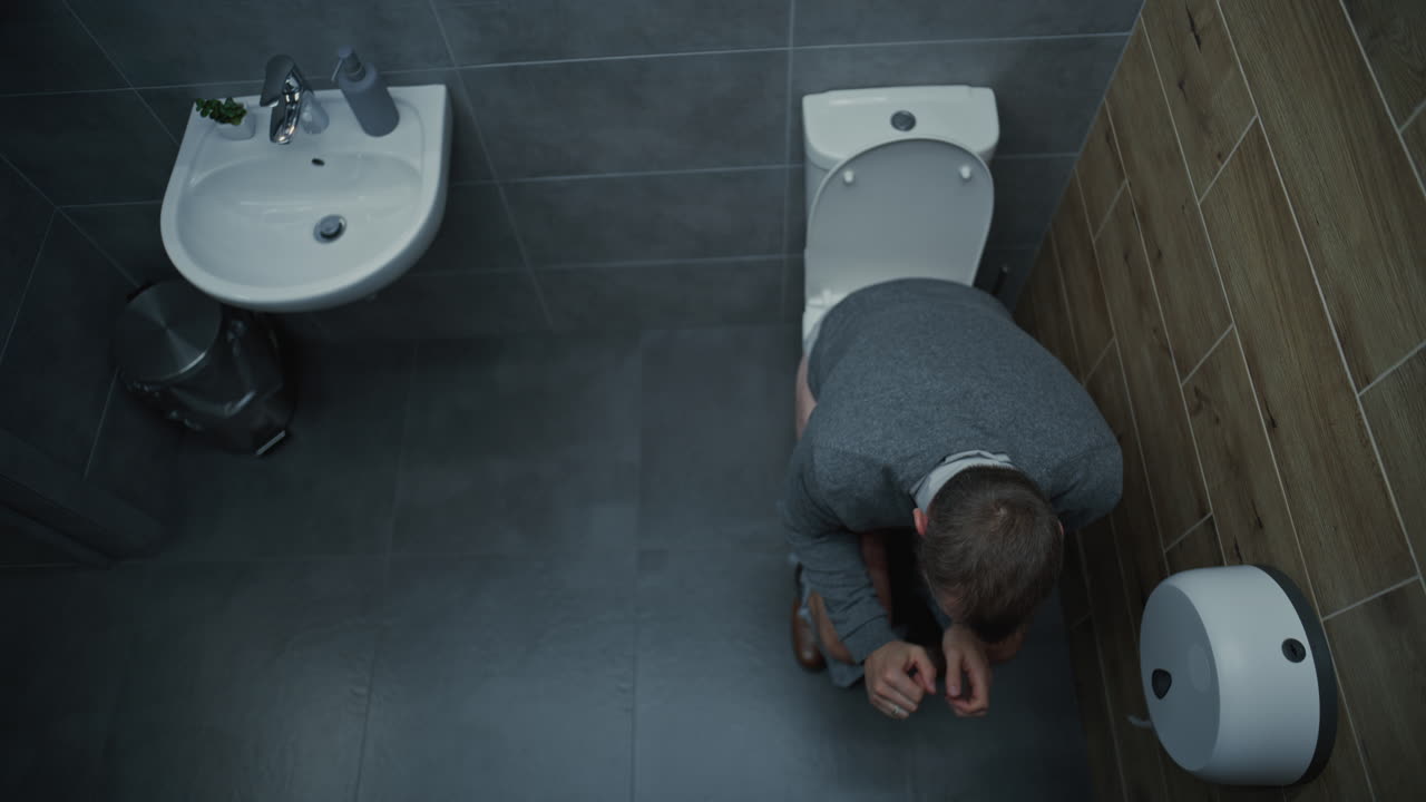 Man Entering in Restroom Sitting on the Toilet and Suffering From Diarrhea and Stomach Ache