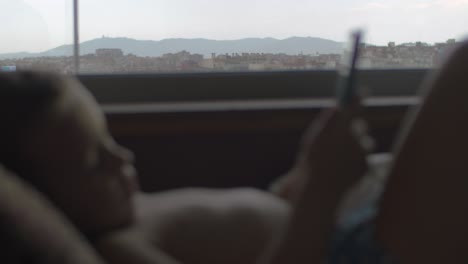 child lying in bed and using touch pad