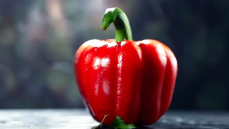 a red bell pepper sitting on top of a table