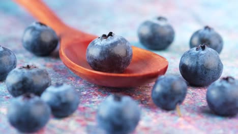 fresh blueberries on a wooden spoon