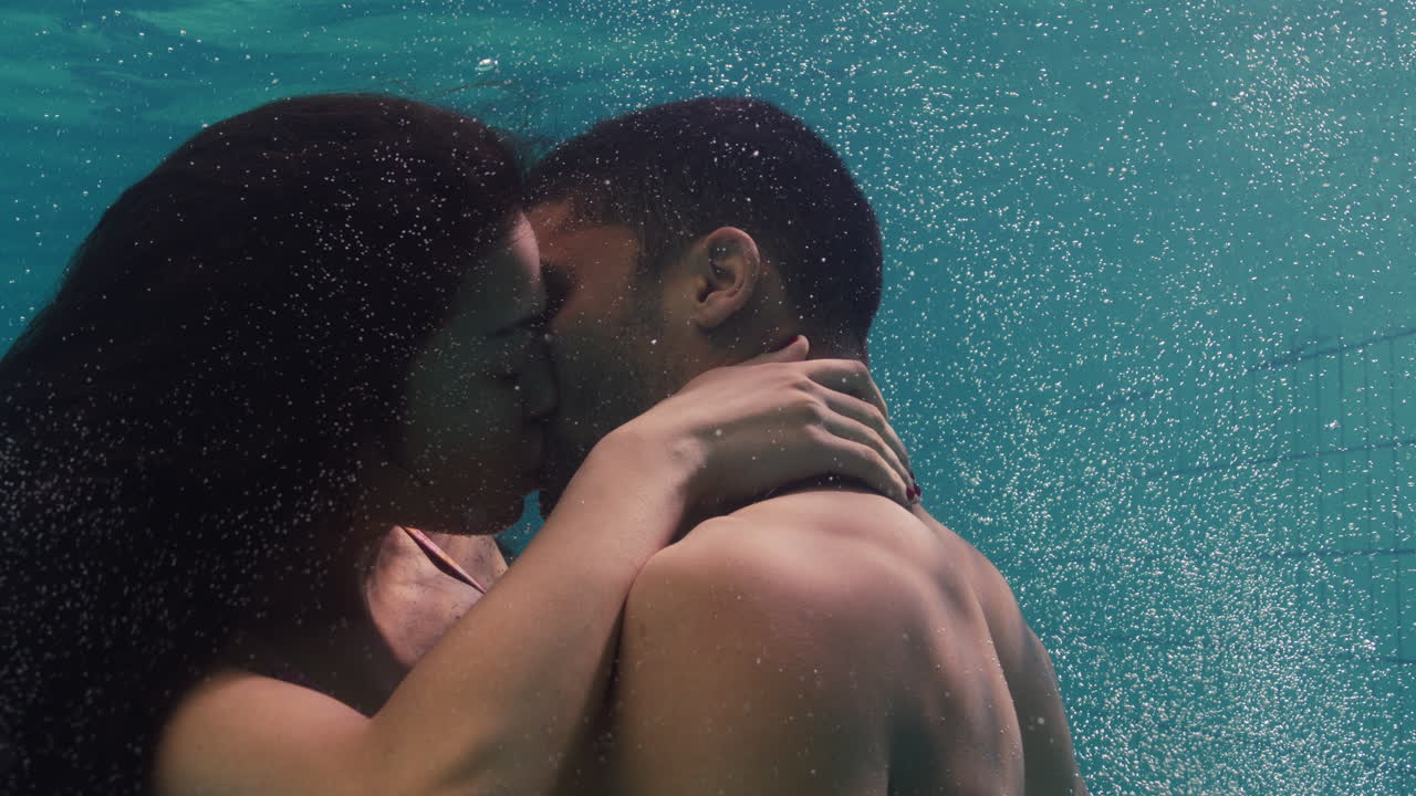 Young Couple Kissing Underwater In Swimming Pool Enjoying Intimate Kiss  Romantic Lovers Submerged In Water Floating With Bubbles In Passionate  Intimacy Free Stock Video Footage Download Clips