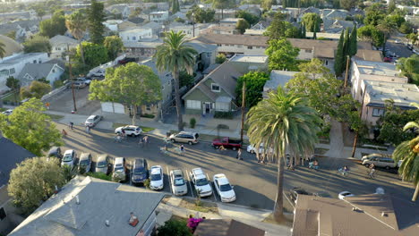 aerial view of people riding bicycles through a suburban neighborhood