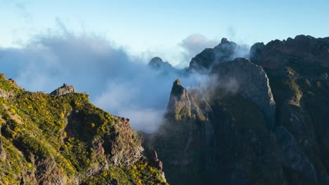 fog time lapse of arieiro mountain rocky peak with tourist on viewpoint