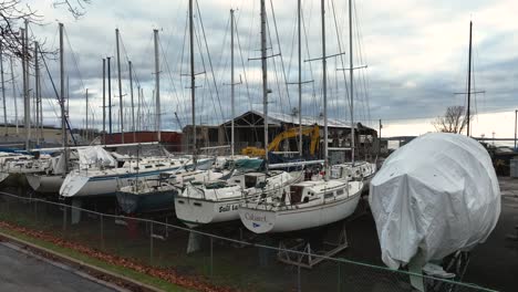 rising while focusing on the boatyard under heavy clouds