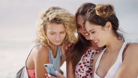 Friends,-phone-selfie-and-women-by-beach