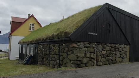 medium close up of a sod roof home in gjogv, faroe islands