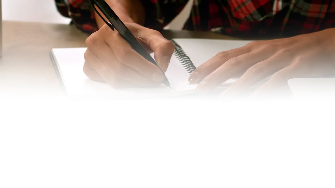 Animation of light over hands of biracial female writing in notebook