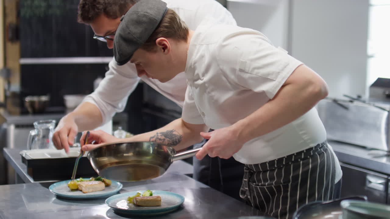 Two Chefs Working Together on Food Orders in Restaurant Kitchen