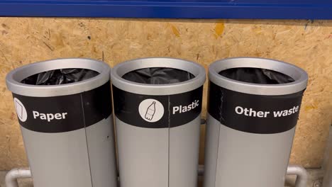 A-close-up-shot-of-recycle-bins-with-symbol-kind-of-garbage-along-side-of-a-road