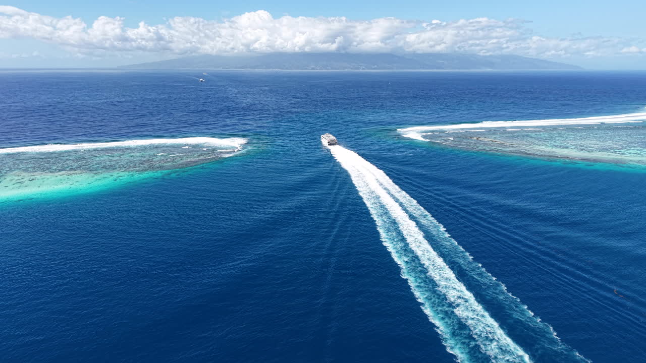 French Polynesia. Drone Shot of Ferry Boat Sailing Between Coral Reefs and Moorea and Tahiti Islands