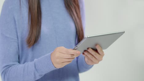 close up of woman using tablet