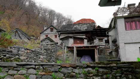 a close-up shot of the rural houses and a garage built from stone in the village of cavergno, switzerland