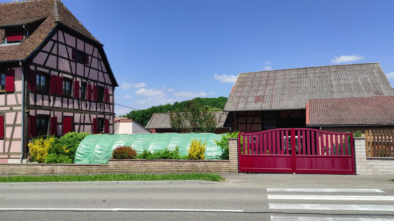 Sundgau, Alsace, France. Traditional half timbered houses of an Alsatian Village. Panning shot.