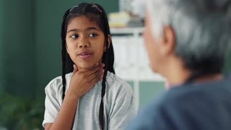 a child with a sore throat being examined by a doctor