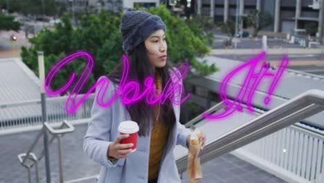 Animation-of-work-it-text-over-asian-woman-with-takeaway-coffee