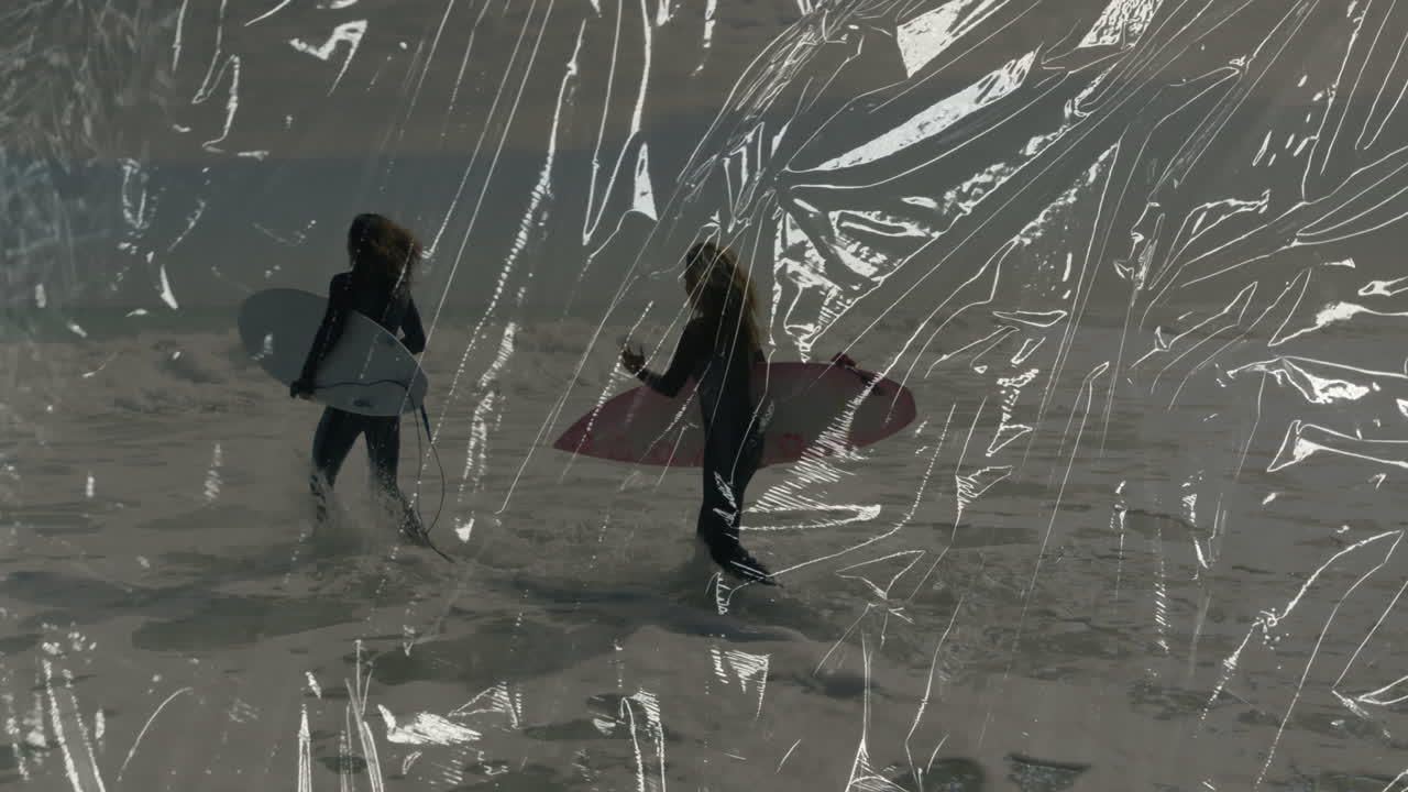 man and woman walking into ocean holding surfboards, featuring crinkle overlay for tech marketing