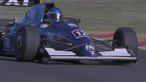 a race car speeds down a stretch of track