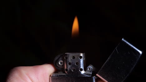 Open-and-light-steel-zippo-lighter,-close-up-view