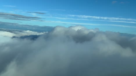 Pilot-POV-flying-over-a-clouded-sky-shot-from-a-jet-cockpit