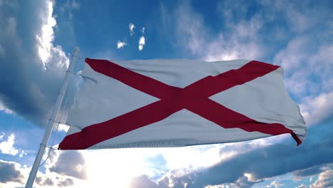 alabama flag on a flagpole waving in the wind in the sky. state of alabama in the united states of america