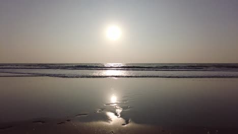radiant sunrise and waves at the beach in maharashtra, india