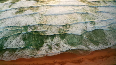 aerial drone shot over the sandy beach in newquay, cornwall, united kingdom